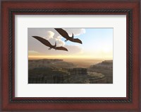 Framed Two Pterodactyl flying dinosaurs soar above a beautiful canyon