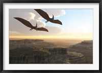 Framed Two Pterodactyl flying dinosaurs soar above a beautiful canyon