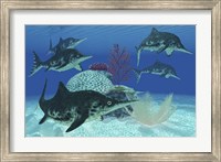 Framed group of large Ichthyosaurus marine reptiles swimming in prehistoric waters