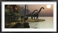 Framed Two Brachiosaurus dinosaurs enjoy a beautiful sunset