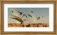 Framed flock of Pterodactyls fly out of a canyon