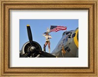 Framed 1940's style majorette pin-up girl on a B-17 bomber with an American flag