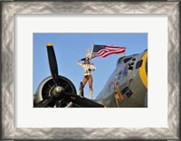 Framed 1940's style majorette pin-up girl on a B-17 bomber with an American flag