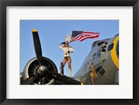 Framed 1940's style majorette pin-up girl on a B-17 bomber with an American flag