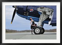 Framed 1940's style pin-up girl resting on the wheel of a TBM Avenger