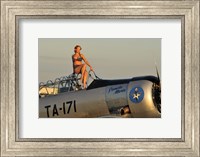 Framed 1940's style pin-up girl sitting on the cockpit of a World War II T-6 Texan