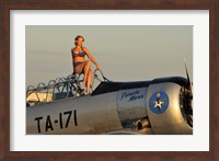 Framed 1940's style pin-up girl sitting on the cockpit of a World War II T-6 Texan