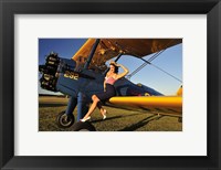 Framed 1940's style pin-up girl sitting on the wing of a Stearman biplane