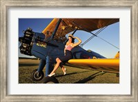 Framed 1940's style pin-up girl sitting on the wing of a Stearman biplane