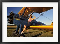 Framed 1940's style pin-up girl sitting on the wing of a Stearman biplane