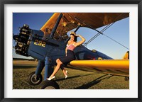 Framed 1940's style pin-up girl sitting on the wing of a Stearman biplane