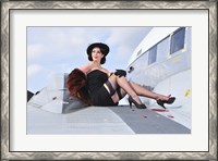 Framed Glamorous woman in 1940's style attire sitting on a vintage aircraft