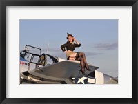 Framed Pin-up girl sitting on the wing of a P-51 Mustang