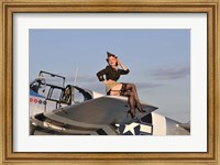 Framed Pin-up girl sitting on the wing of a P-51 Mustang