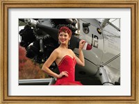 Framed Redhead pin-up girl in 1940's style dancer attire holding on to a vintage aircraft propeller