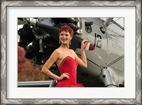 Framed Redhead pin-up girl in 1940's style dancer attire holding on to a vintage aircraft propeller