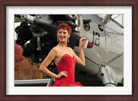 Framed Redhead pin-up girl in 1940's style dancer attire holding on to a vintage aircraft propeller