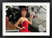 Framed Redhead pin-up girl in 1940's style dancer attire holding on to a vintage aircraft propeller