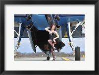 Framed 1940's style pin-up girl in cocktail dress posing in front of a TBM Avenger