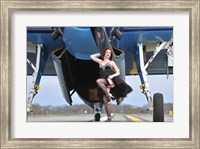 Framed 1940's style pin-up girl in cocktail dress posing in front of a TBM Avenger