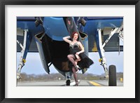 Framed 1940's style pin-up girl in cocktail dress posing in front of a TBM Avenger