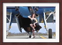 Framed 1940's style pin-up girl in cocktail dress posing in front of a TBM Avenger