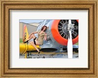 Framed 1940's style pin-up girl posing on a T-6 aircraft