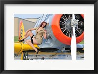 Framed 1940's style pin-up girl posing on a T-6 aircraft