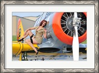 Framed 1940's style pin-up girl posing on a T-6 aircraft