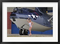 Framed pin-up girl posing with a Catalina seaplane