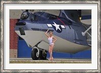 Framed pin-up girl posing with a Catalina seaplane