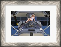 Framed Retro pin-up girl posing with a World War II era PBY Catalina seaplane