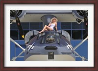 Framed Retro pin-up girl posing with a World War II era PBY Catalina seaplane