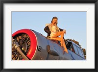 Framed 1940's style aviator pin-up girl posing with a vintage T-6 Texan aircraft