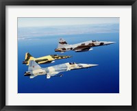 Framed Three F-5E Tiger II fighter aircraft in flight