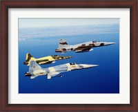 Framed Three F-5E Tiger II fighter aircraft in flight