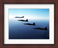 Framed Three F-5E Tiger IIs fly in formation with a Learjet 25