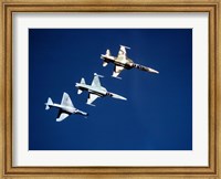 Framed Two F-5 Tiger II's and an A-4E Skyhawk in flight above the Pacific Ocean