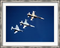 Framed Two F-5 Tiger II's and an A-4E Skyhawk in flight above the Pacific Ocean