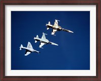 Framed Two F-5 Tiger II's and an A-4E Skyhawk in flight above the Pacific Ocean