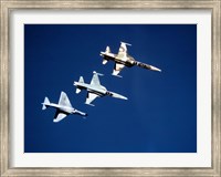 Framed Two F-5 Tiger II's and an A-4E Skyhawk in flight above the Pacific Ocean
