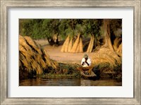 Framed Local Man Fishing and Piles of Straw for Hatch, Okavango Delta, Botswana