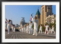 Framed People practicing Taiji with sword on the Bund in the morning, Shanghai, China