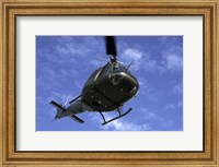 Framed Former US Air Force Bell UH-1E Huey helicopter in flight