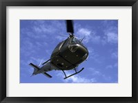 Framed Former US Air Force Bell UH-1E Huey helicopter in flight