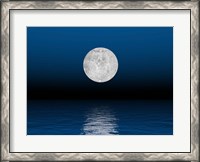 Framed Beautiful full moon against a deep blue sky over the ocean