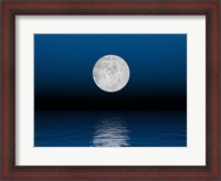 Framed Beautiful full moon against a deep blue sky over the ocean