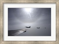Framed F-16 Fighting Falcon fighters over the wing of a KC-135 Stratotanker