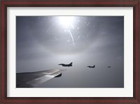 Framed F-16 Fighting Falcon fighters over the wing of a KC-135 Stratotanker