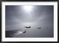 Framed F-16 Fighting Falcon fighters over the wing of a KC-135 Stratotanker